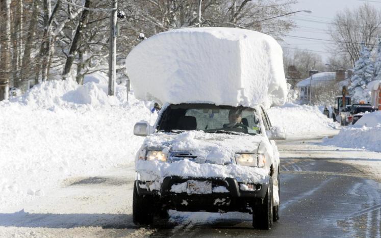 photo of vehicle with 2 feet of snow on roof